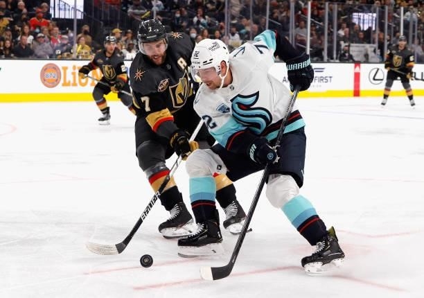 Joonas Donskoi of the Seattle Kraken, skating in his 400th NHL game, tries to control the puck against Alex Pietrangelo of the Vegas Golden Knights,...