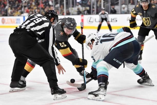 Mark Stone of the Vegas Golden Knights faces off with Jared McCann of the Seattle Kraken during the third period at T-Mobile Arena on October 12,...