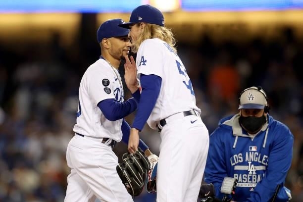 Mookie Betts and Phil Bickford of the Los Angeles Dodgers react after beating the San Francisco Giants 7-2 in game 4 of the National League Division...