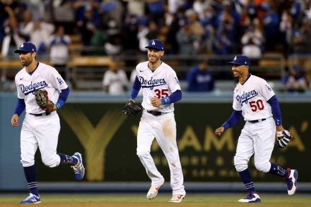 Chris Taylor, Cody Bellinger and Mookie Betts of the Los Angeles Dodgers react after beating the San Francisco Giants 7-2 in game 4 of the National...