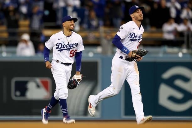 Cody Bellinger and Mookie Betts of the Los Angeles Dodgers react after beating the San Francisco Giants 7-2 in game 4 of the National League Division...