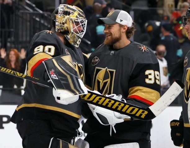 Robin Lehner and Laurent Brossoit of the Vegas Golden Knights celebrate on the ice after the team's 4-3 victory over the Seattle Kraken in the...