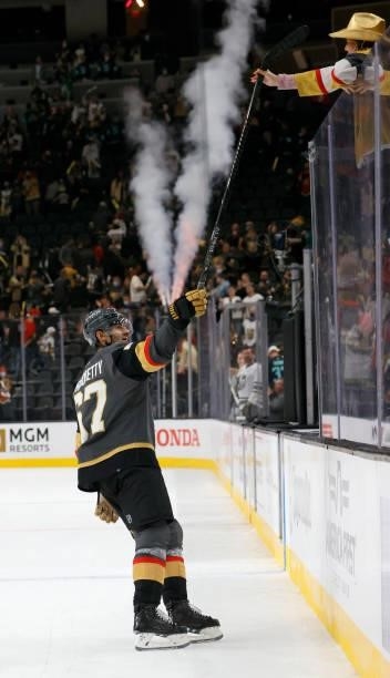 Max Pacioretty of the Vegas Golden Knights hands a stick to a fan after being named the third star of the game following the team's 4-3 victory over...