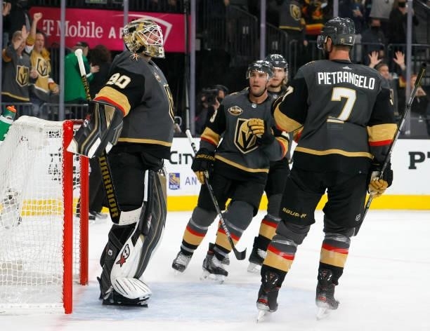 Robin Lehner of the Vegas Golden Knights celebrates with teammates as time expires in their game against the Seattle Kraken in the Kraken's inaugural...