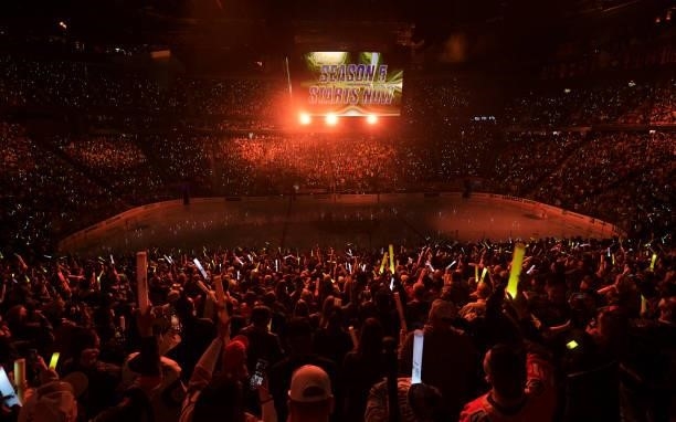 Fans wave light sticks during a pregame show before the Seattle Kraken's inaugural regular-season game against the Vegas Golden Knights at T-Mobile...
