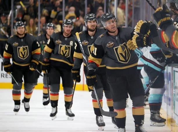 Jonathan Marchessault of the Vegas Golden Knights celebrates with teammates on the bench after scoring a first-period goal against the Seattle Kraken...
