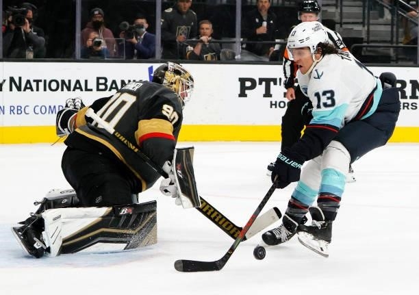 Robin Lehner of the Vegas Golden Knights makes a save against Brandon Tanev of the Seattle Kraken in the first period of the Kraken's inaugural...