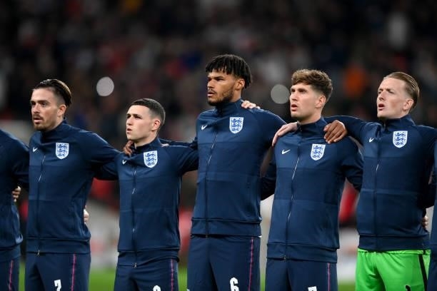 Jack Grealish, Phil Foden, Tyrone Mings, John Stones and Jordan Pickford of England sing the national anthem prior to the 2022 FIFA World Cup...