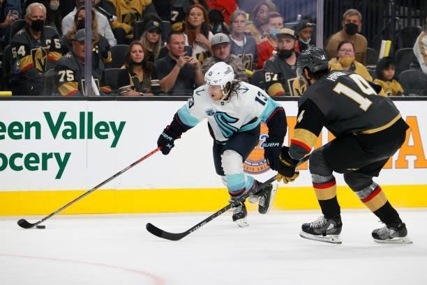 Brandon Tanev of the Seattle Kraken skates with the puck against Nicolas Hague of the Vegas Golden Knights in the third period of the Kraken's...