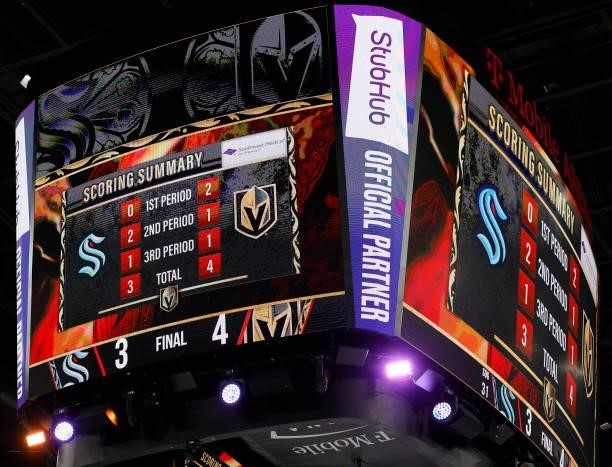 The scoreboard shows the 4-3 final score of the Seattle Kraken's loss in their inaugural regular-season game to the Vegas Golden Knights at T-Mobile...