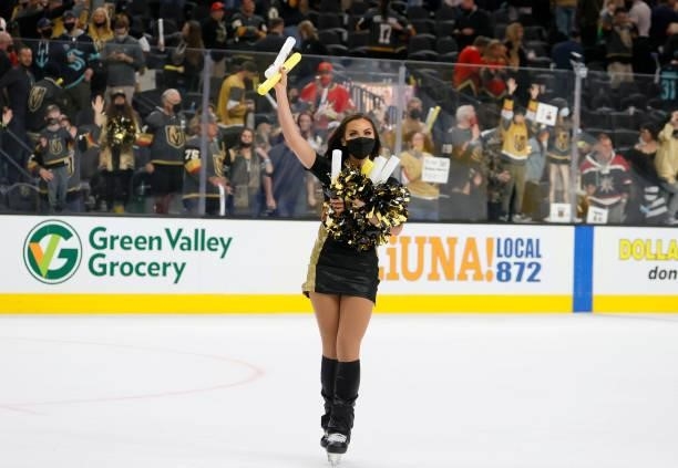 Member of the Knights Guard collects light sticks thrown onto the ice after the Vegas Golden Knights' 4-3 victory over the Seattle Kraken in the...