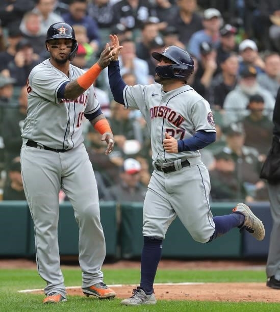 Jose Altuve and Martin Maldonado of the Houston Astros celebrate after scoring runs against the Chicago White Sox at Guaranteed Rate Field on October...