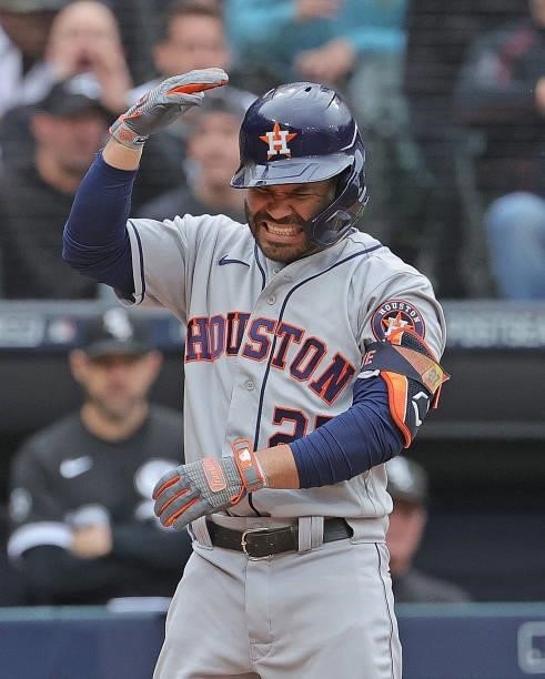 Jose Altuve of the Houston Astros reacts after being hit by a pitch against the Chicago White Sox at Guaranteed Rate Field on October 12, 2021 in...