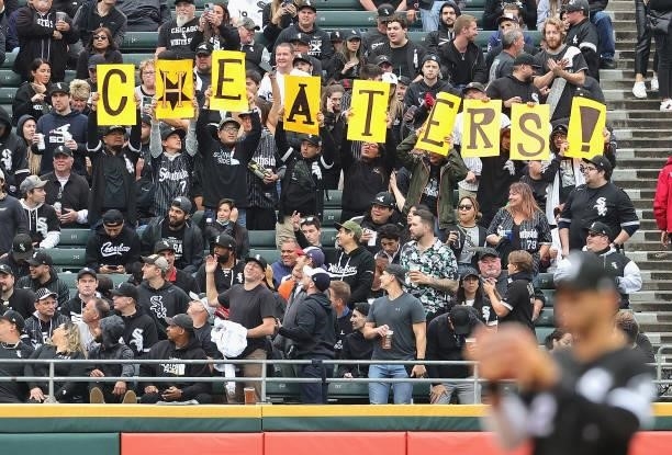 Fans of the Chicago White Sox in left field hold up a sign during a game against the Houston Astros at Guaranteed Rate Field on October 12, 2021 in...