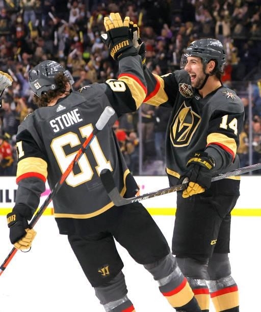 Nicolas Hague and Mark Stone of the Vegas Golden Knights celebrate after they assisted on a second-period goal by teammate Max Pacioretty against the...