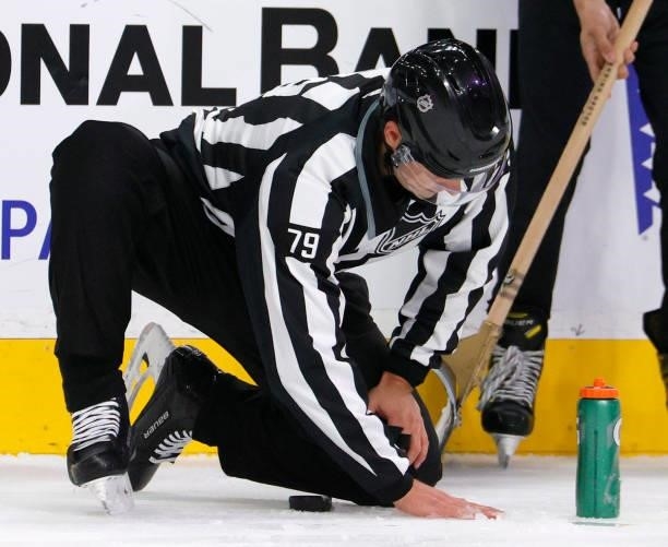 Linesman Kiel Murchison makes a minor ice repair in the third period of a game between the Seattle Kraken and the Vegas Golden Knights during the...