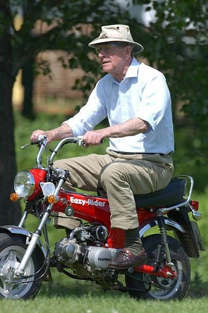 Prince Philip, the Duke of Edinburgh, rides a monkey-bike at the Royal Windsor Horse Show May 16, 2002 in Windsor, England.