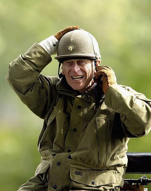 The Duke of Edinburgh puts on a helmet during the Royal Windsor Horse Show on May 17, 2003 at Home Park, Windsor Castle in Windsor, England.