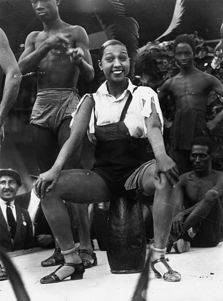 American born singer and dancer Josephine Baker , surrounded by male dancers at the Folies Bergere.