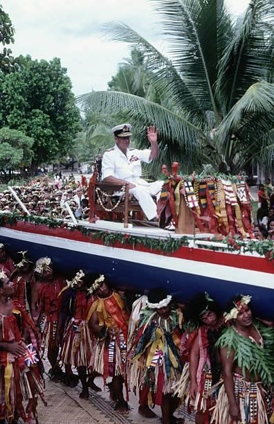 Prince Philip the Duke of Edinburgh is carried aloft on a canoe through the streets of the Pacific island of Tuvalu on October 26, 1982 during the...