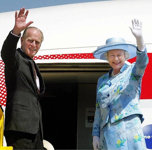 Britain's Queen Elizabeth II and The Duke of Edinburgh wave goodbye as they board their plane at Abuja airport, Nigeria, 06 December 2003. The Queen...