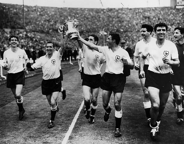 Tottenham Hotspur footballers celebrating with the FA Cup at Wembley after beating Burnley 3 - 1 to win the trophy for the second year running. Left...