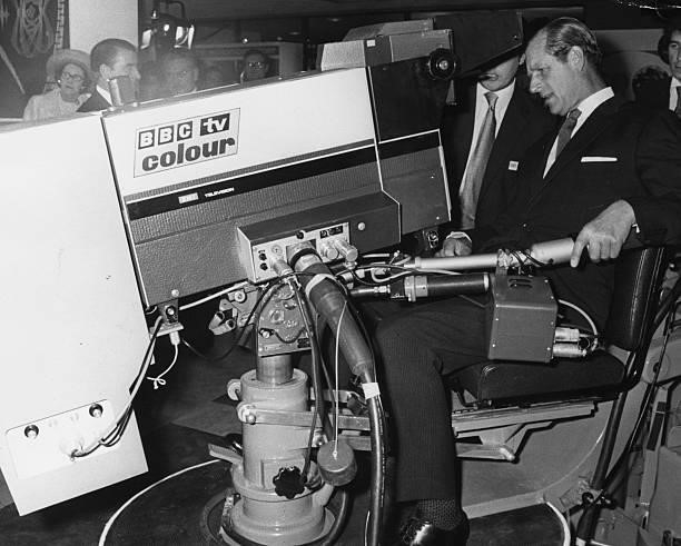 Prince Philip, the Duke of Edinburgh, tries his hand as a television cameraman at a technical exhibition arranged in conjunction with the 50th...