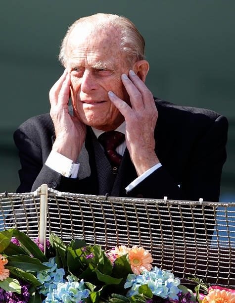 Prince Philip, Duke of Edinburgh listens to electronic string quartet Escala perform prior to the start of The Derby as he attends Derby Day during...
