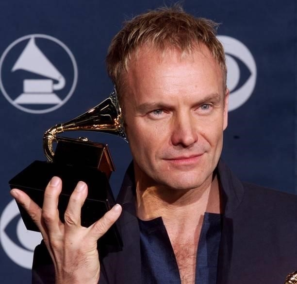 Singer Sting holds his Grammy up to his ear after winning for Best Male Pop Vocal Performance for "Brand New Day