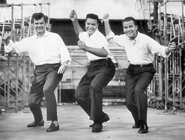 Chubby Checker leads Conway Twitty and Dick Clark through the dance the Twist, 7th September 1960.