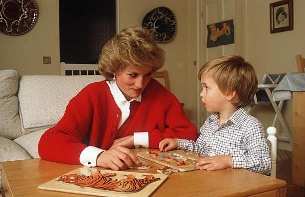 Princess Diana Helping Prince William With A Jigsaw Puzzle Toy In His Playroom At Home In Kensington Palace
