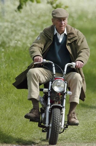 Prince Philip, Duke of Edinburgh rides mini motorcycle around the Royal Windsor Horse Show on May 13, 2005 in Windsor, England.