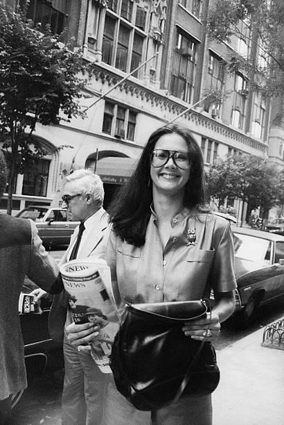 Lynda Carter walking on the street with The Daily News; circa 1970; New York.