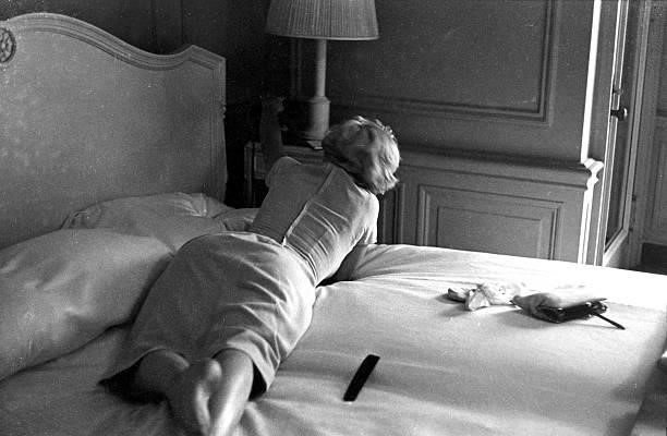 Marilyn Monroe lies on a bed talking on a telephone in a room at the Hotel St. Regis in 1954 in New York, New York.