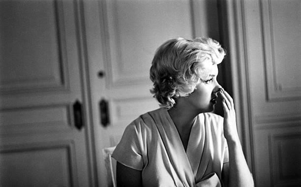 Marilyn Monroe with a cup of tea in a room at the Hotel St. Regis in 1954 in New York, New York.
