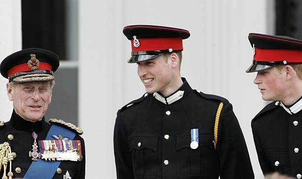 Prince Philip, Duke of Edinburgh talks with his grandsons Prince William and Prince Harry at the Sovereign's Parade at Sandhurst Military Academy on...
