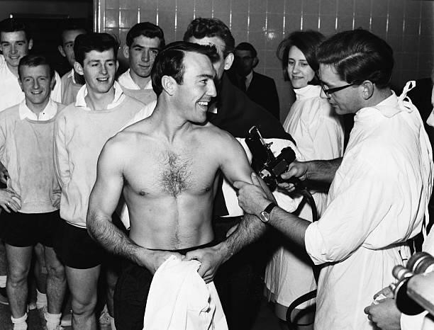 Tottenham Hotspur's soccer players watch as teammate Jimmy Greaves receives an influenza vaccination.