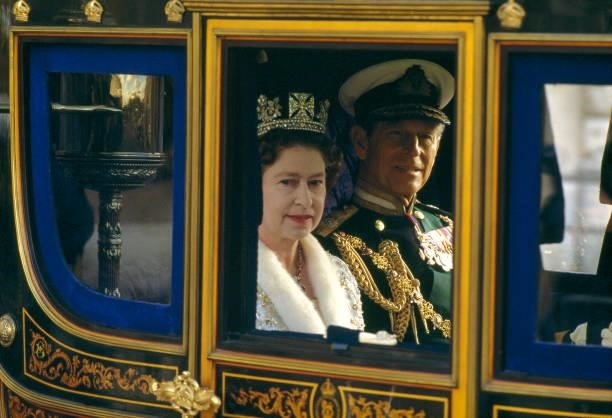 View of Queen Elizabeth II and her husband, Prince Philip, Duke of Edinburgh, as they ride in the royal carriage, London, England, July 23, 1986. The...