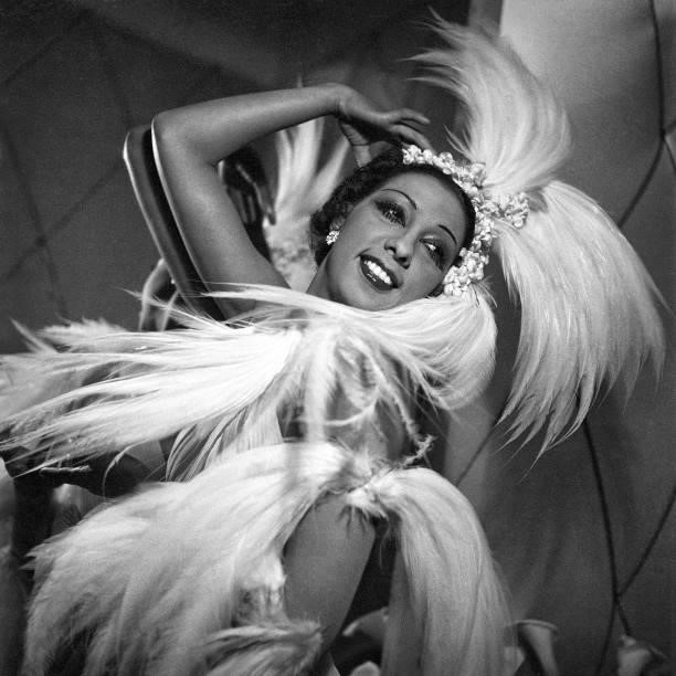 Publicity portrait of American singer, dancer, and actress Josephine Baker in feathers backstage, 1946.