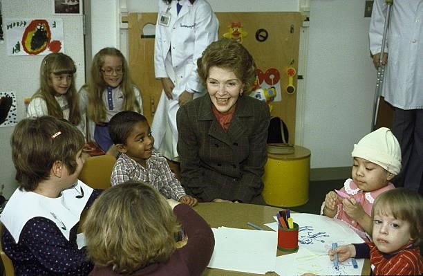First Lady Nancy Reagan surrounded by children during a visit to Children's Hospital.