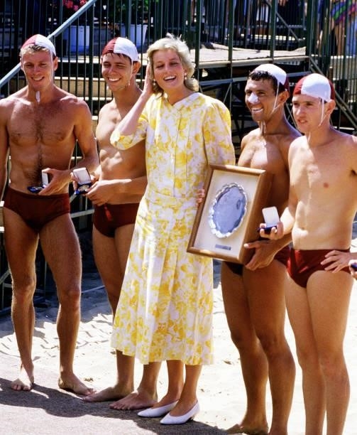 The Princes of Wales meeting lifeguards at Terrigal beach during her visit to Australia, January 1988. She is wearing a Paul Costelloe dress.