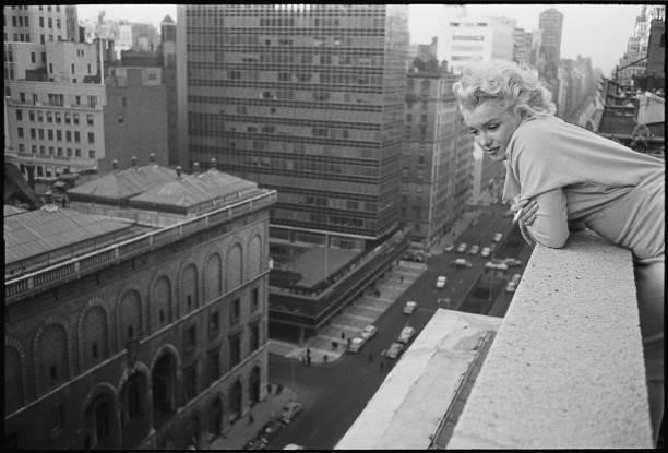 American actress Marilyn Monroe leans over the balcony of the Ambassador Hotel in March 1955 in New York City, New York.