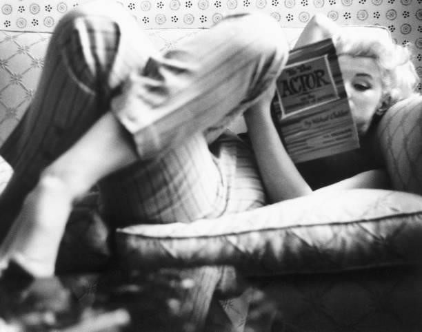 Actress Marilyn Monroe reads the book "To the Actor: On the Technique of Acting" by Michael Chekhov in a quiet moment at the Ambassador Hotel in...