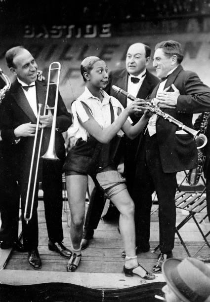American music hall star Josephine Baker , playing the clarinet at the Caf' Conc festival at the Stade Buffalo velodrome, Montrouge, Paris, 1926....