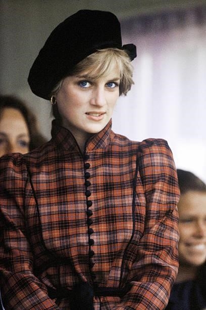 Diana, Princess of Wales, wearing a tartan dress designed by Caroline Charles and a black Tam o' shanter style hat, attends the Braemar Highland...