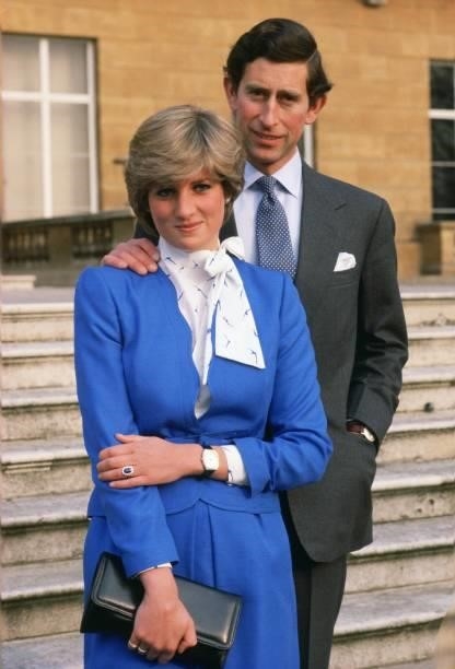Lady Diana Spencer reveals her sapphire and diamond engagement ring while she and Prince Charles, Prince of Wales pose for photographs in the grounds...