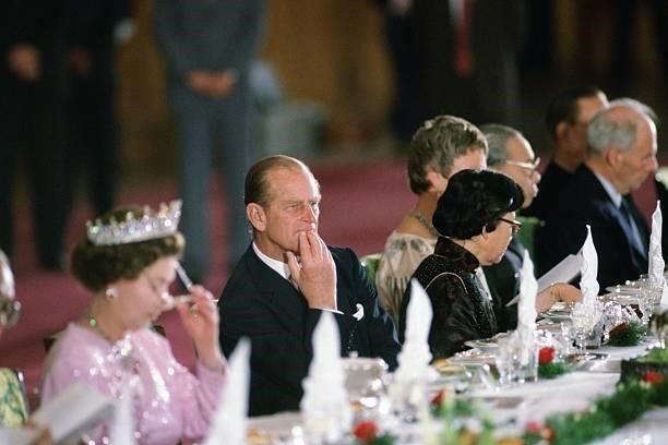 Prince Philip, Duke of Edinburgh attends a banquet in the Great Hall of the People in Peking, China, October 1986. Queen Elizabeth II is to his right.