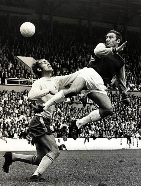 24th August 1970, Division 1, West Ham United v Chelsea, West Ham United's Jimmy Greaves, right, jumps for the ball with Chelsea's John Dempsey