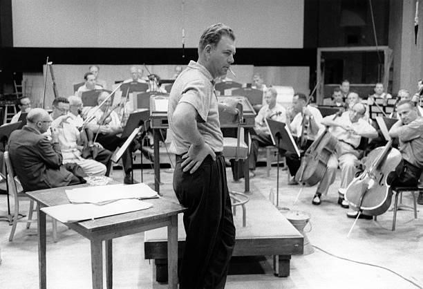 Composer and arranger Nelson Riddle in a studio with an orchestra, circa 1950.