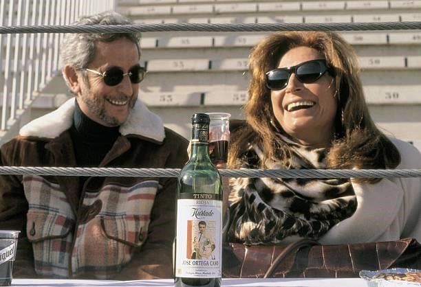 Rocio Jurado and Juan Pardo, singers Toasting with a bottle of wine with the image of the bullfighter Ortega Cano, the singer´s husband, on the label